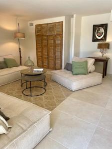 a living room with two couches and a table at La Bastide Chamarrée in Camaret-sur-Aigues