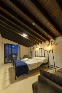 a large bedroom with a bed and a couch at Shire Küçükköy in Ayvalık