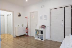 a white room with a closet and a bed and a book shelf at Aura Station Ciampino 'Roma, StazioneFS, Aeroporto' in Ciampino +31 photos