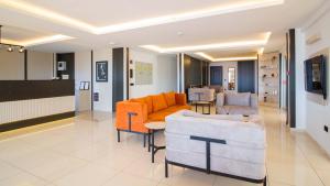 a living room with two couches and a table at Kas Maki Hotel in Kaş