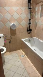 a bathroom with a bath tub and a toilet at زهرة الهدا in Al Hada +11 photos