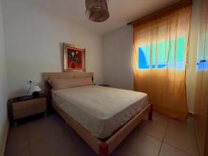 a small bedroom with a bed and a window at Delfines III Solo Familias Serviplaya in Playa de Xeraco +204 photos