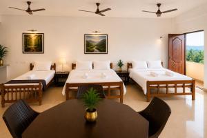 a hotel room with two beds and a table at THE MOUNT VIEW CASTLE HOTELS and RESORTS in Tenkāsi
