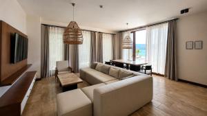 a living room with a couch and a table at İskelem Otel in Akyaka