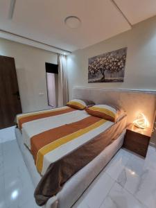 a bedroom with a large bed in a room at Modern flat in a central location in Kenitra in Kenitra