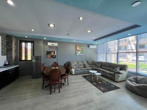 a living room with a couch and a table at Host Apartments in Shkodër