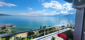 a view of a large body of water from a balcony at Aldo's apartments in Pogradec