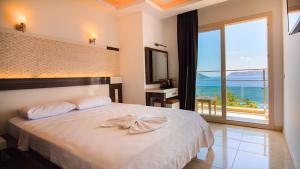 a bedroom with a bed with a view of the ocean at Kas Maki Hotel in Kaş +63 photos