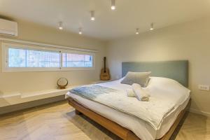 a bedroom with a large bed and a window at Happy Cactus 1BR Apartment In Batroun Souks in Batroûn
