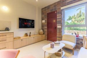a living room with a red door and a table at Happy Cactus 1BR Apartment In Batroun Souks in Batroûn