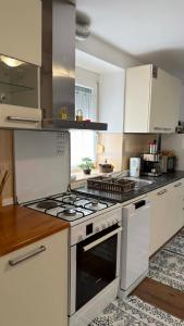 a kitchen with an oven and a stove top at Apartma SAAAN in Šempas