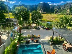 a view of a resort with a swimming pool and mountains at Tam Cốc mountain view Villa in Ninh Binh