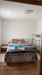a bedroom with a bed with blue towels on it at Apartma SAAAN in Šempas