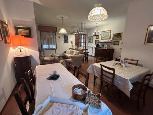 a dining room and living room with tables and chairs at Borgo Caprari in Albinea