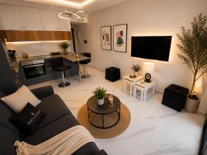 a living room with a couch and a table at Studıo Iskele 150 in Aglantzia