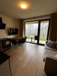 a living room with a couch and a table at Apartman Jasan Spot in Železná Ruda