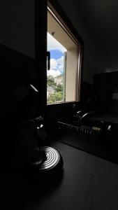 a dark room with a window and a keyboard at L'échappée du Verdon in Esparron-de-Verdon