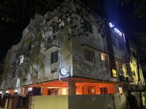 a building with a clock in front of it at night at Crayons Hotel in Chennai