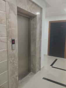 a elevator with a door with a red light on it at Nozeht el soltan in Potinville