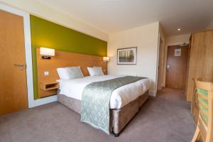 a bedroom with a large bed with a green wall at Ramsey Park Hotel in Ramsey +61 photos
