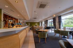 a restaurant with a bar and tables and chairs at Ramsey Park Hotel in Ramsey