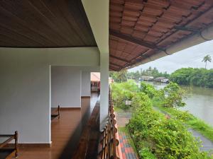 a building with a view of a river at Backwater Breeze in Kumarakom