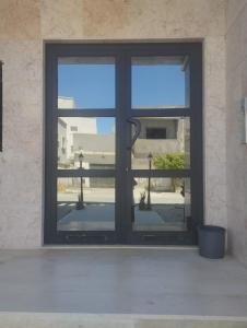 a window with a view of a balcony at Nozeht el soltan in Potinville