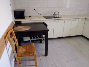 a small kitchen with a table and a laptop on it at Hostel Pod Lasem in Altanka