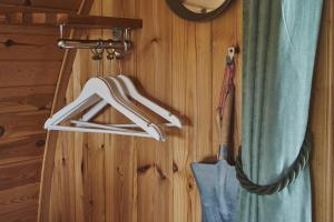 a towel rack hanging on a wooden wall at Iona Pods in Iona