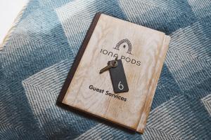 a book with a lock on top of a bed at Iona Pods in Iona