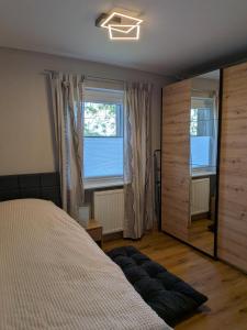 a bedroom with a bed and a large window at Ferienwohnung "Pfoten & Komfort" in Butjadingen