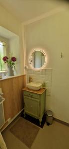a bathroom with a sink and a mirror at Le Fourneau Rond in Soings-en-Sologne +13 photos