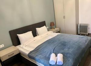 a bedroom with a large bed with slippers on it at Forest view Tsaghkadzor in Tsaghkadzor