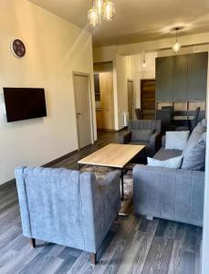 a living room with two couches and a table at Forest view Tsaghkadzor in Tsaghkadzor