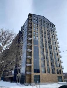 a tall building with glass windows on the side of it at Forest view Tsaghkadzor in Tsaghkadzor