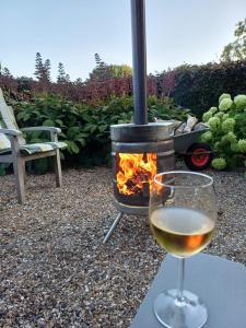 a glass of white wine next to a fire pit at B & B it Heech in Ferwerd