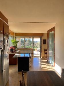 a kitchen with a table in the middle of a room at CASA Arce in Boqueijón
