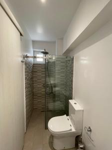 a bathroom with a toilet and a glass shower at MyLiving in Kardamaina +18 photos