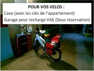 a red scooter parked in a room at Appartement avec terrasse 42m2 in Saint-Martin-de-Valamas