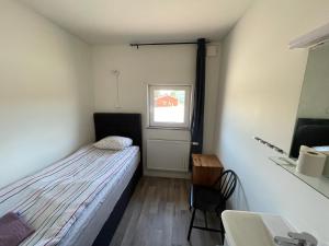 a small bedroom with a bed and a window at 17 Rum och Kök in Harmånger