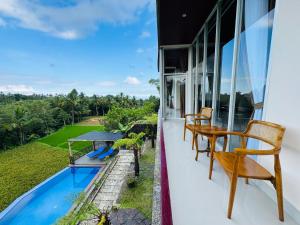 a balcony with a table and chairs and a swimming pool at Nona Lodge in Tetebatu