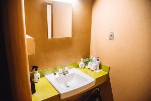 a bathroom with a white sink and a mirror at Tanakaya in Kurobe +71 photos