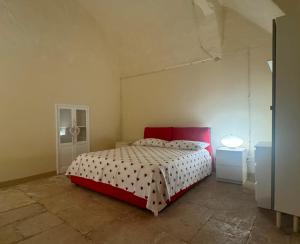 a bedroom with a red and white bed in a room at MaryClouBert-Home in Molfetta +13 photos