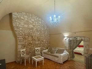 a room with a bed and a stone wall at MaryClouBert-Home in Molfetta