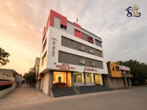 a building with a sign on the side of it at Hotel Shree Maya Comfort Inn in Ujjain
