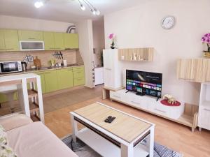 a living room with a couch and a table and a kitchen at Summer Dream, Nesebar Fort Club, Sunny Beach in Sunny Beach