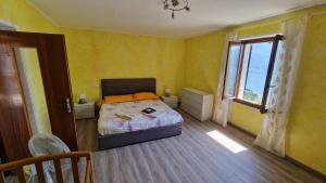 a small bedroom with a bed and a window at casa Belvedere in San Siro