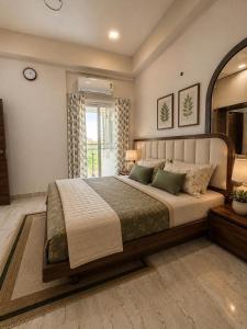 a bedroom with a large bed in a room at Neelaashray Sea view apartment in Ratnagiri