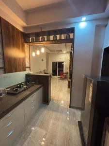 a kitchen with a stove and a counter top at Neelaashray Sea view apartment in Ratnagiri