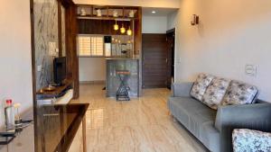 a living room with a couch and a television at Neelaashray Sea view apartment in Ratnagiri